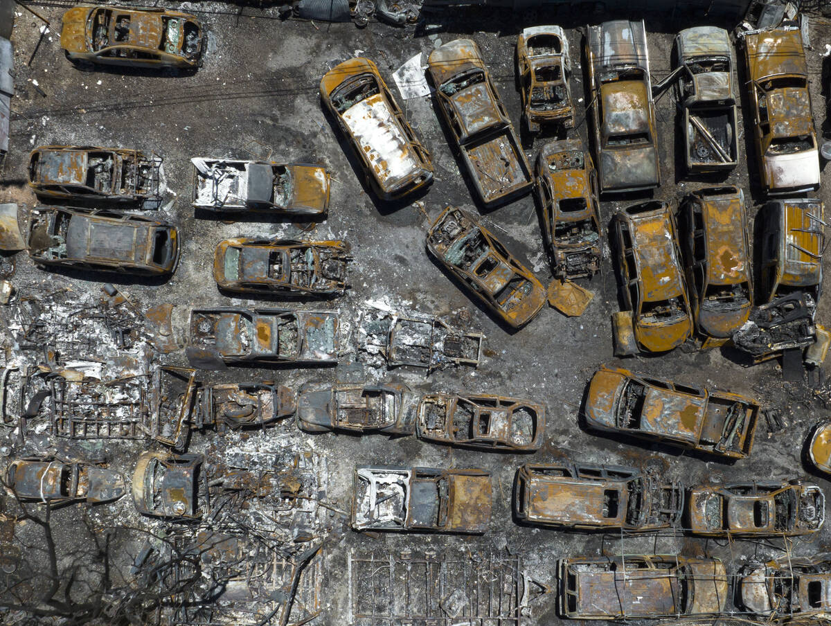 An aerial photograph taken on Monday, June 20, 2022 shows destroyed vehicles outside a condomin ...