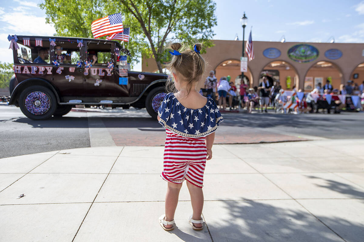Olivia Ruecking watches as the parade passes down Nevada Way during the two-day Damboree event ...