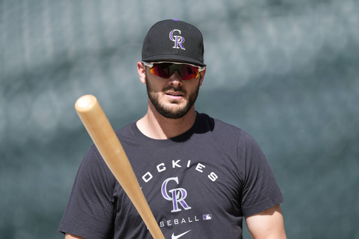 Injured Colorado Rockies outfielder Kris Bryant warms up before a baseball game against the Cle ...
