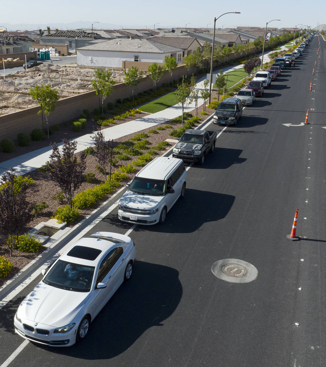 Cars line up to get free gas from Smith’s Marketplace on Thursday June 16, 2022, in Las ...