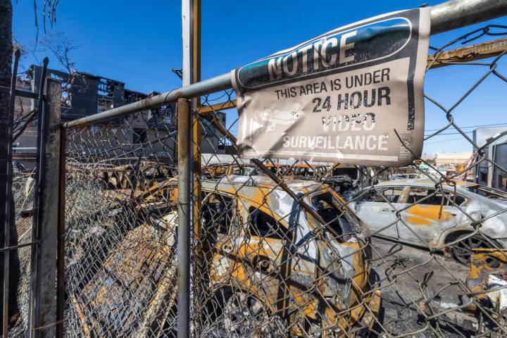Burned out cars on the lot at Perfect Auto Body after a fire swept from stalled construction at ...