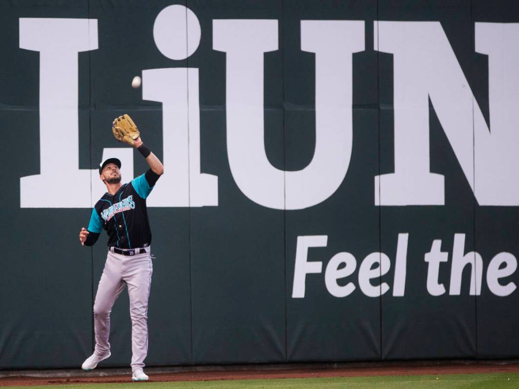 Colorado Rockies third baseman Kris Bryant makes a catch on the warning track during a rehab as ...