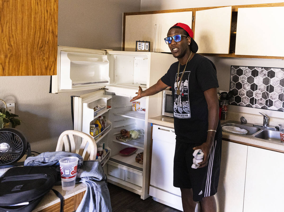 Tenerese Nunn, a resident at Ridge on Charleston Apartment complex, shows his empty refrigerato ...
