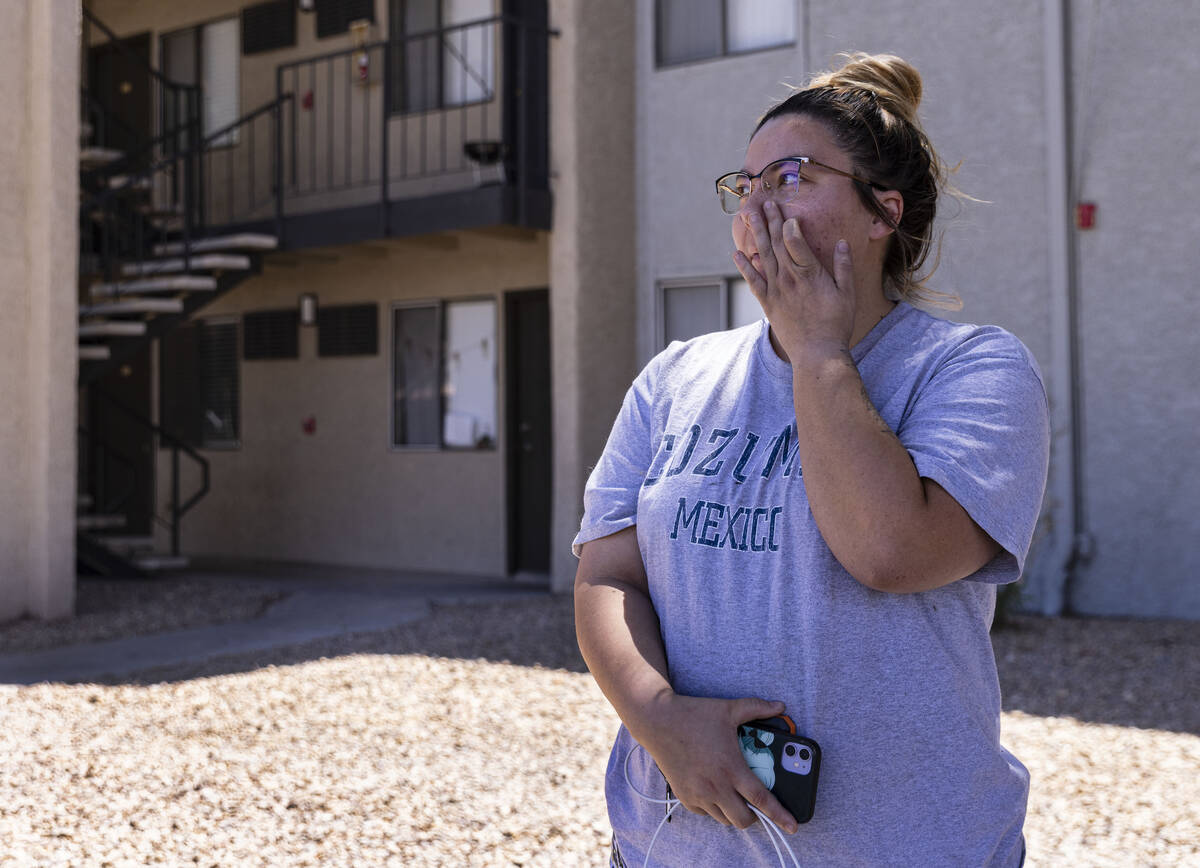 Kelly Suarez, a resident at the Ridge on Charleston Apartment complex, gets emotional as she sp ...
