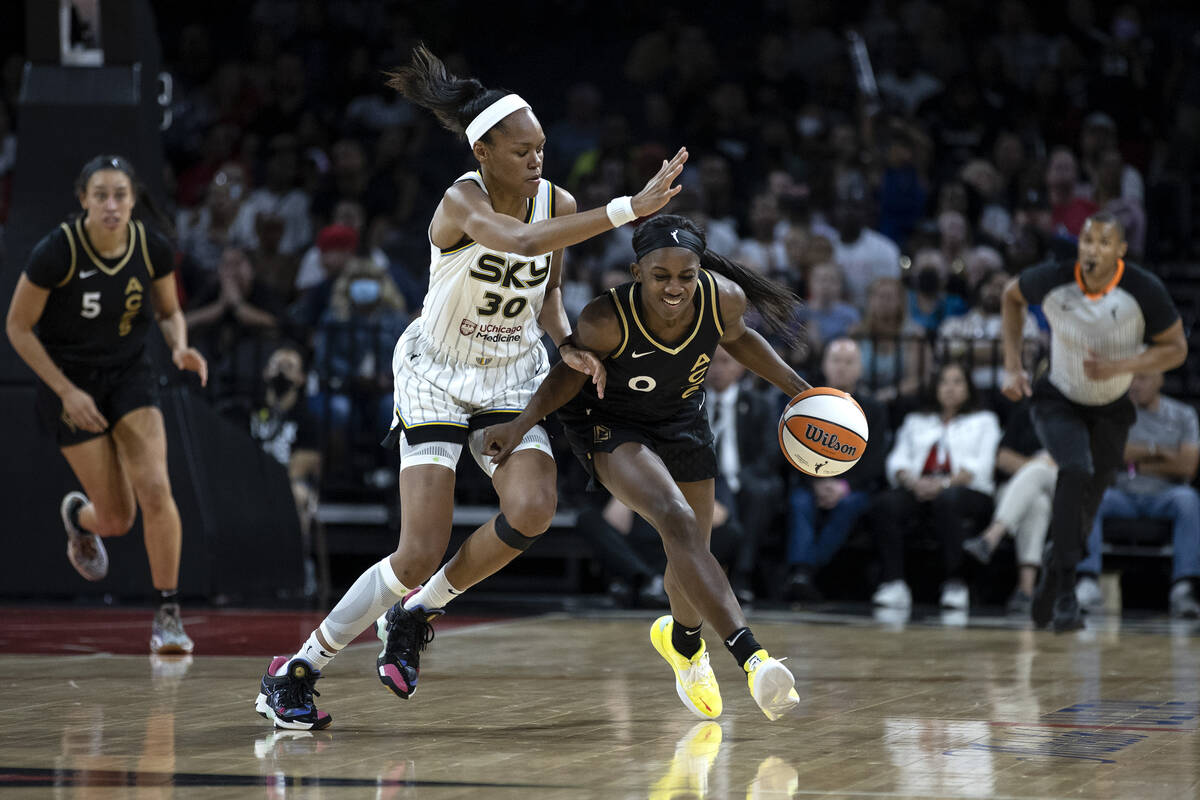 Las Vegas Aces guard Jackie Young (0) drives around Chicago Sky forward Azura Stevens (30) duri ...