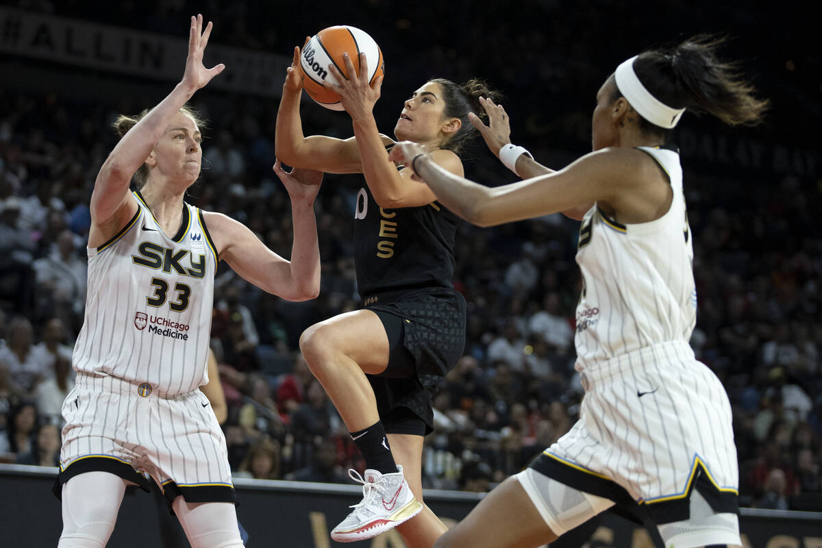 Las Vegas Aces guard Kelsey Plum (10) shoots against Chicago Sky forward Emma Meesseman (33) an ...
