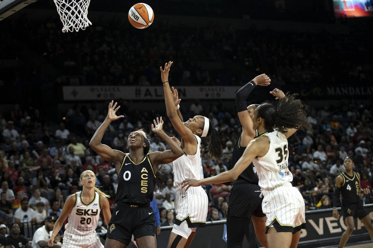 Las Vegas Aces guard Jackie Young (0) watches as her shot bounces off the back board while Chic ...