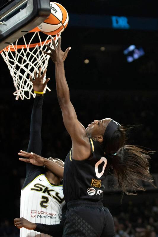 Las Vegas Aces guard Jackie Young (0) shoots against Chicago Sky guard Kahleah Copper (2) durin ...