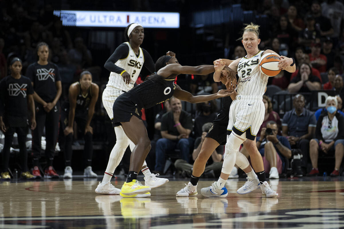 Las Vegas Aces guard Jackie Young (0) fouls Chicago Sky guard Courtney Vandersloot (22) while g ...