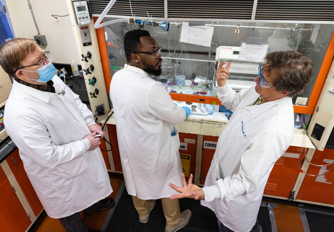 UNLV radiochemistry professor Ken Czerwinski, right, works with Frederic Poineau, left, radioch ...