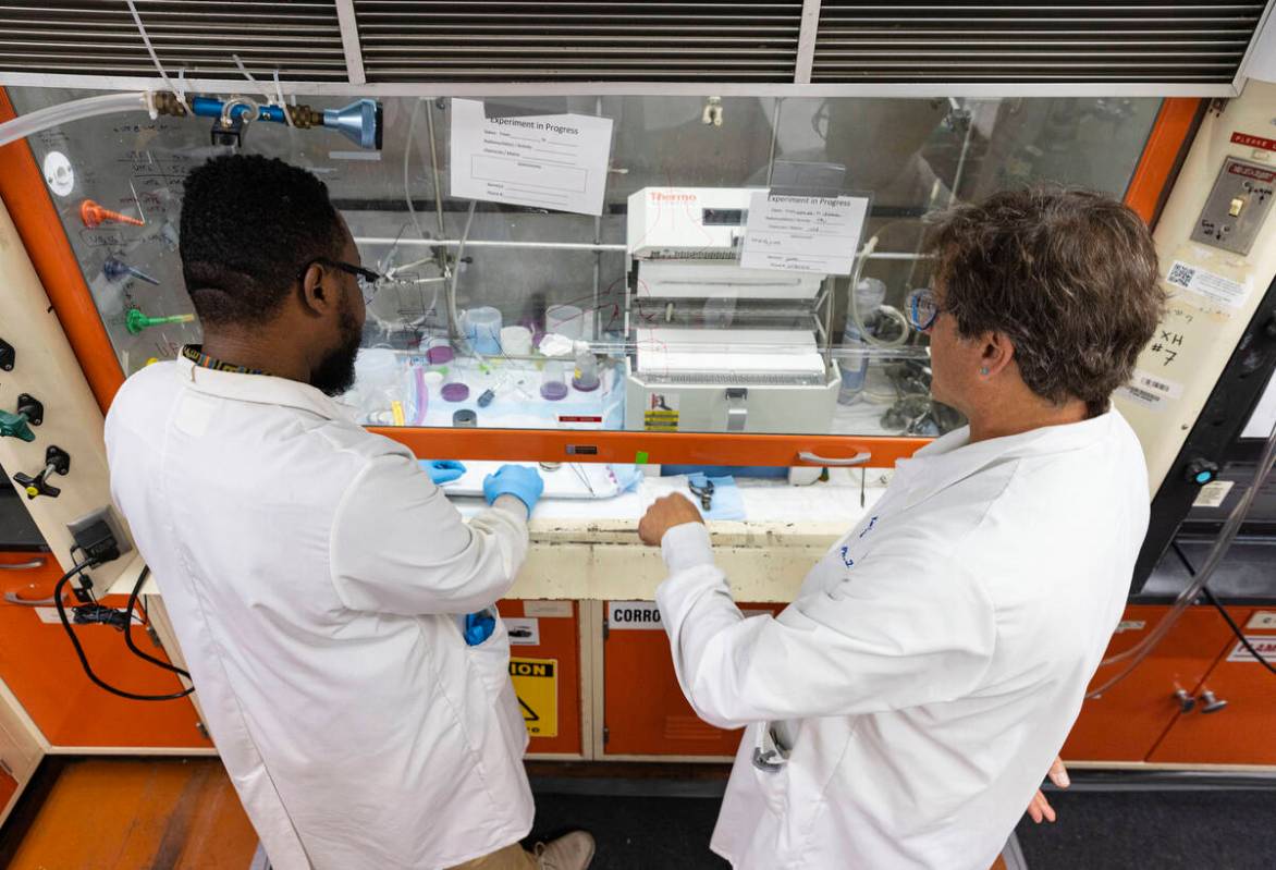 UNLV radiochemistry professor Ken Czerwinski, right, works with Dr. James Louis-Jean, Phd radio ...