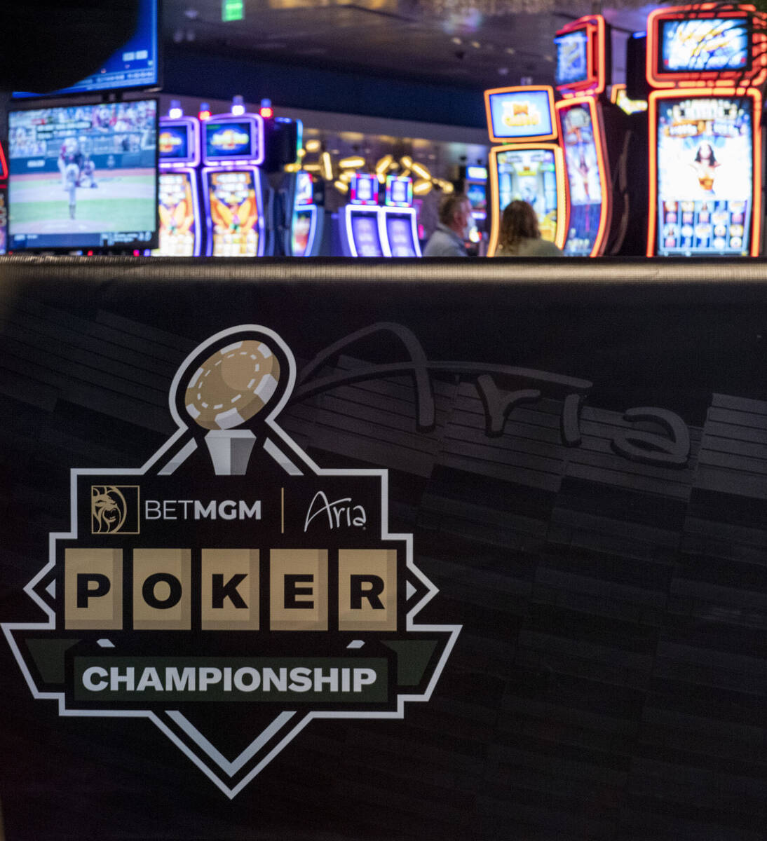 A person walks by a banner for the BetMGM Poker Championship at the Aria on Wednesday, June 22, ...