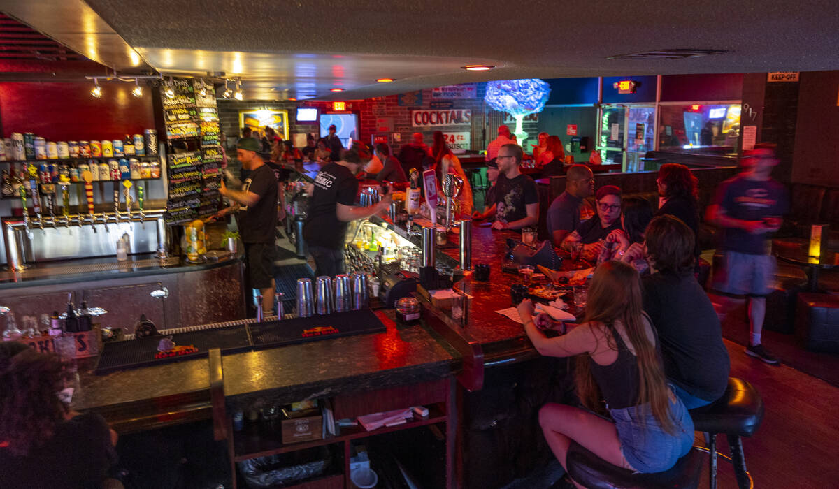 The bar begins to fill up with patrons for the start of the Atomic Liquors 70th anniversary par ...