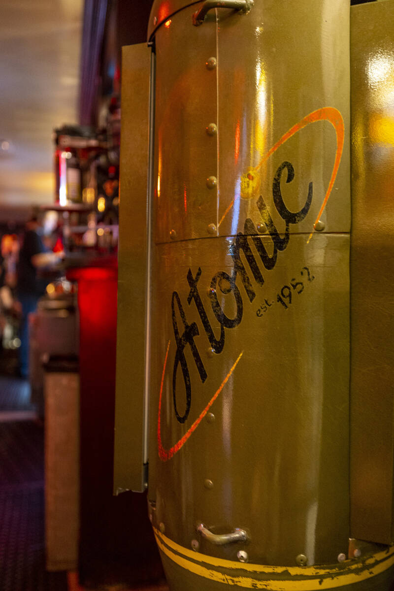 An original logo is painted on the side of a small fridge during the start of the Atomic Liquor ...