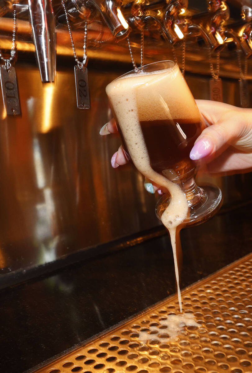 Devin Costentine, Atomic Liquors lead bartender pours Joseph James Suave Felon #003 into a glas ...