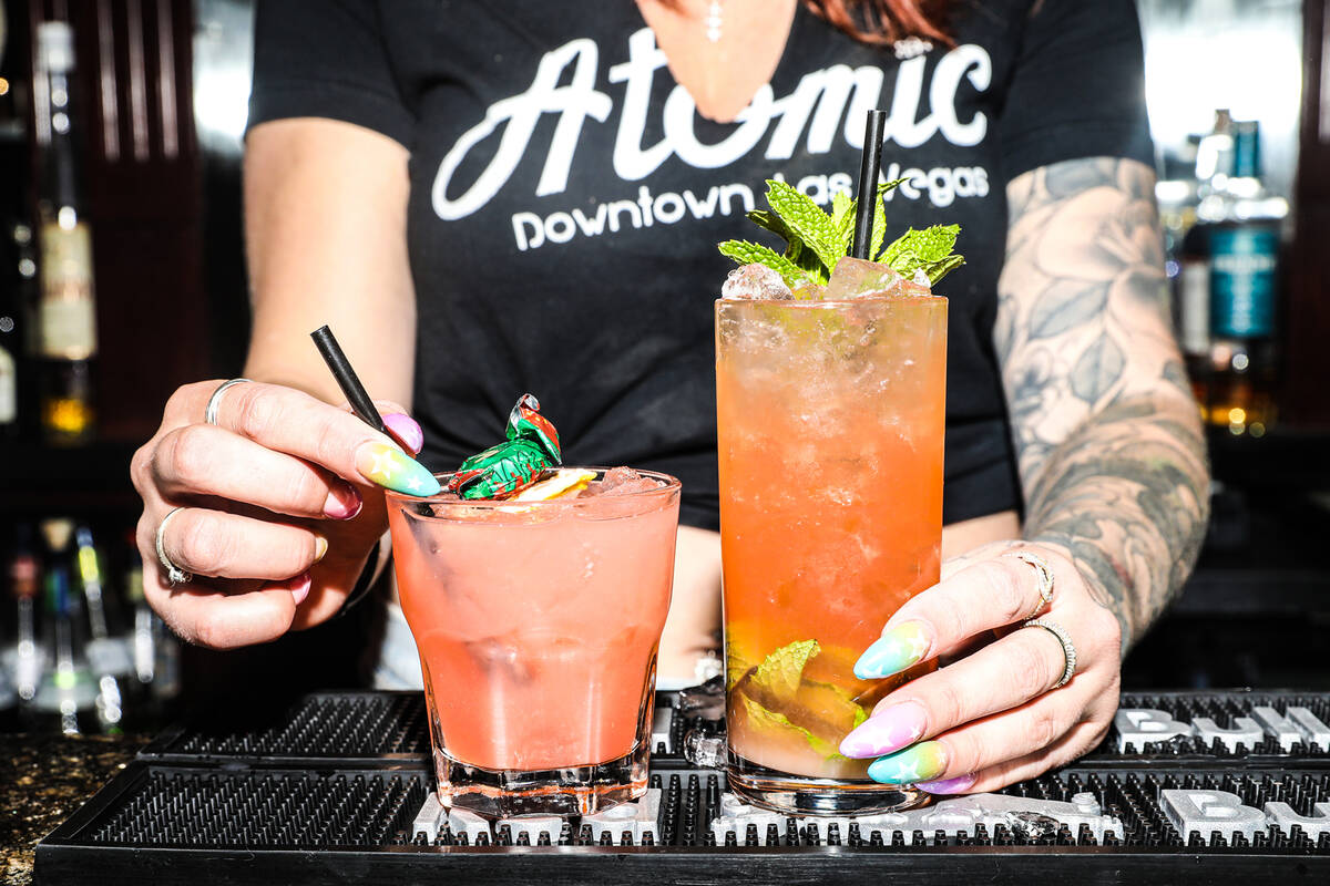 Devin Costentine, assistant manager and bartender, presents the Strawberry Fields cocktail, lef ...