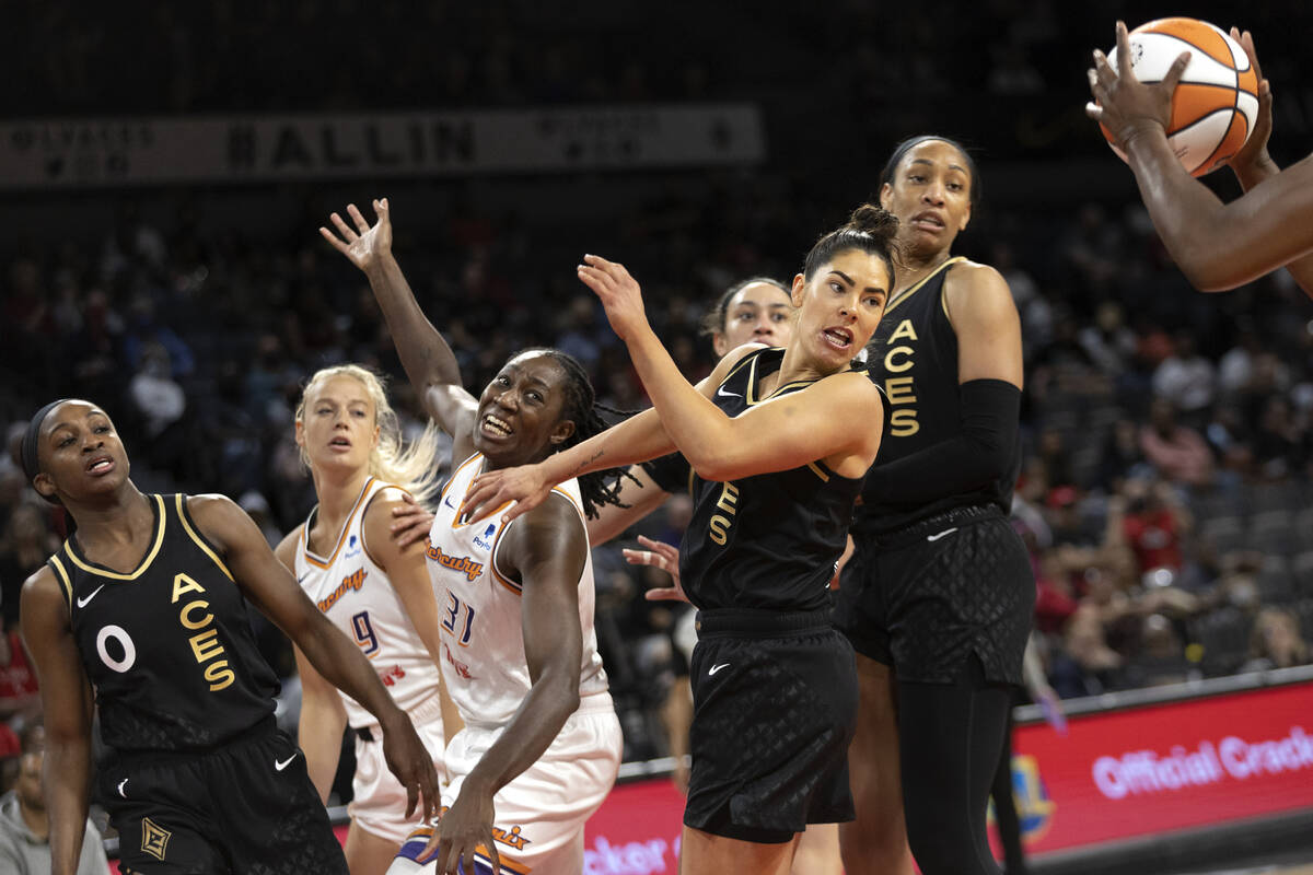 Las Vegas Aces guard Chelsea Gray, right, catches a pass from guard Jackie Young (0) while guar ...