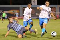 Tacoma Defiance Eric Kinzner (72) clears the ball away from Las Vegas Lights Roberto Molina (11 ...