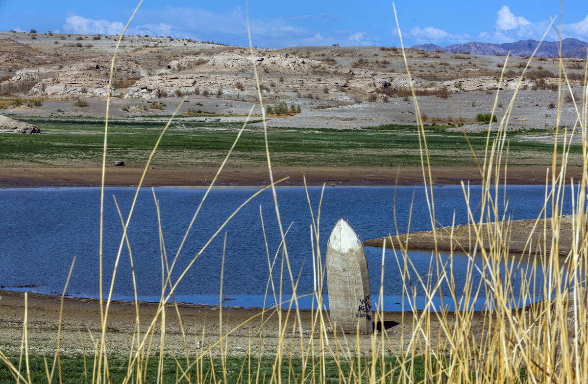 A boat is stuck straight up along the shoreline as water levels continue to drop at the Lake Me ...