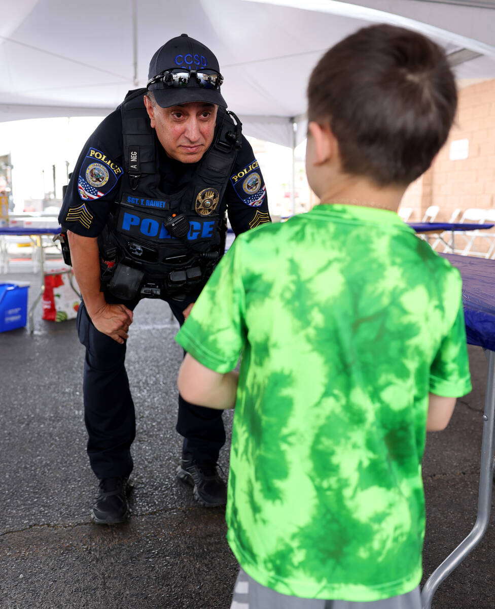 Clark County School District Police Sgt. Tom Rainey talks to a young person during a fundraiser ...