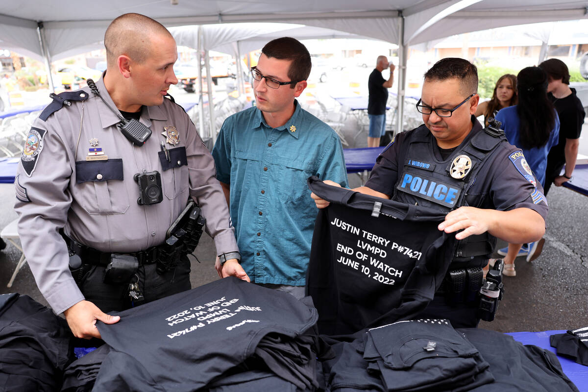 Sean Terry, son of late Las Vegas police Detective Justin Terry, center, checks out T-shirts ho ...