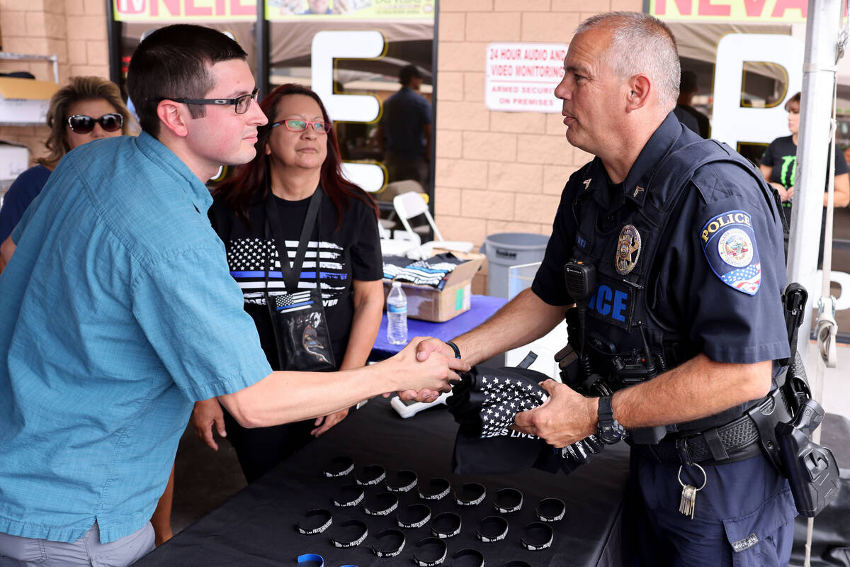 Clark County School District Police Department officer Terry McAninch greets Sean Terry, son of ...