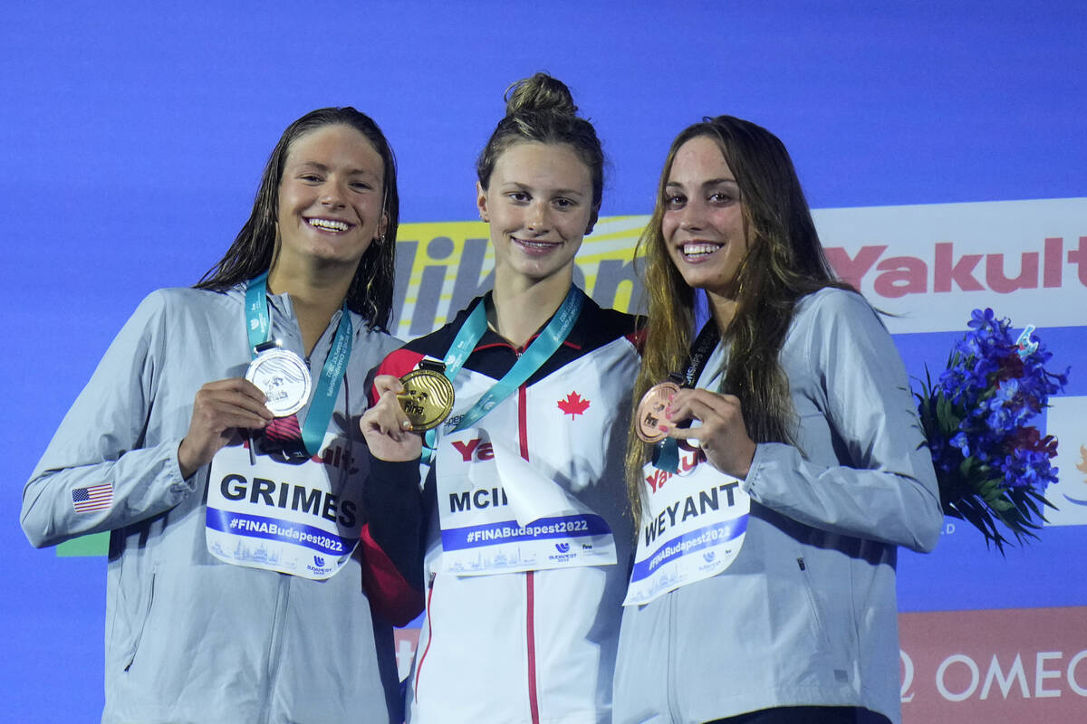 Summer McIntosh, center, of Canada, second place Katie Grimes of the United States and Las Vega ...