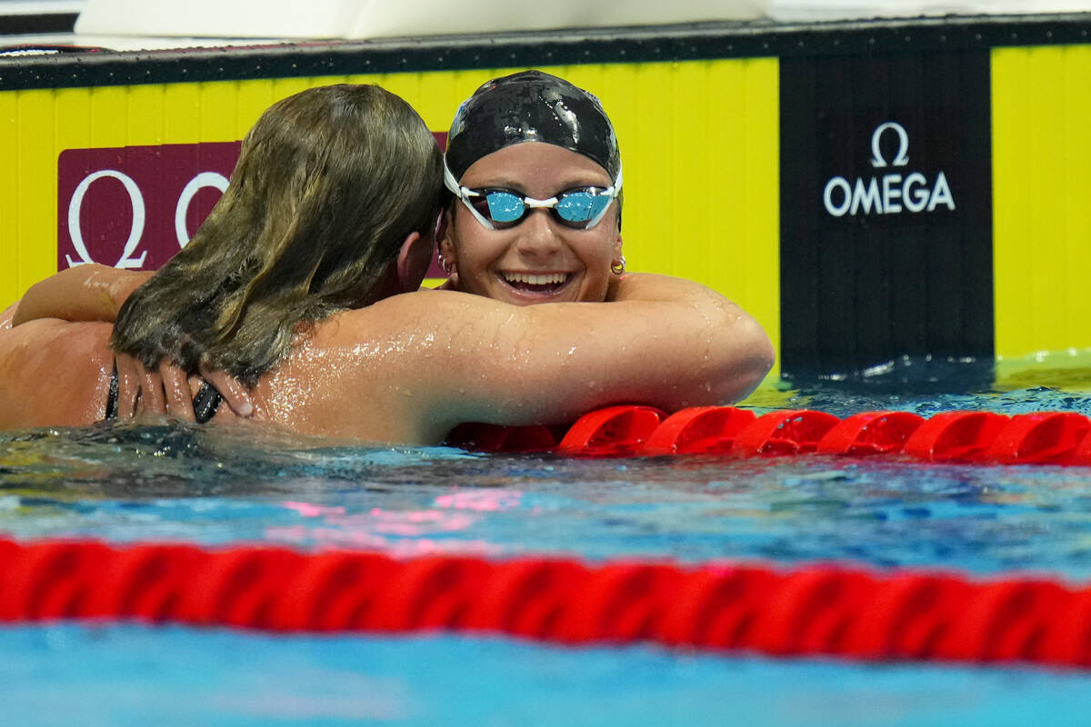 Second place Katie Grimes of the United States and Las Vegas celebrates with winner Katie Ledec ...