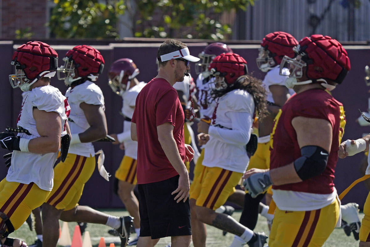 Southern California head coach Lincoln Riley, center, watches his team go through running drill ...