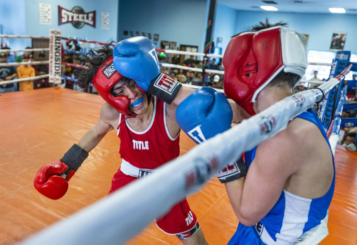 Fhennix Garcia, left, takes a punch to the face from Ramiro Espinoza their 110-pound match duri ...