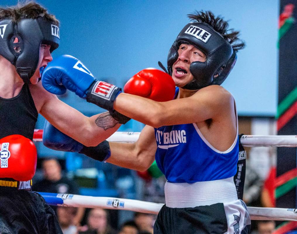 Trip Westfall, left, and Juan Enriquez trade punches in their 138-pound match during the 2nd An ...