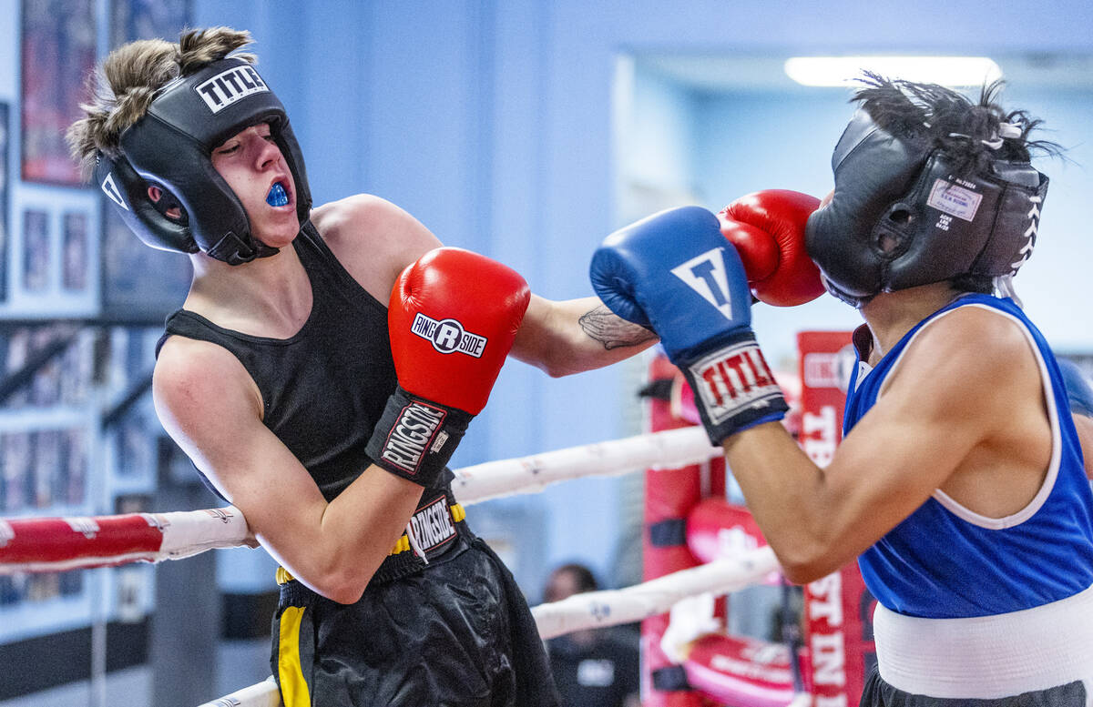 Trip Westfall, left, connects with a punch to the chin of Juan Enriquez in their 138-pound matc ...