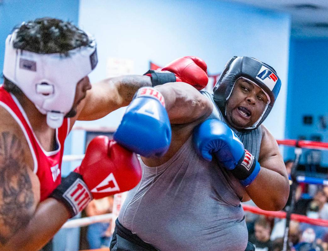 Angel Lopez, left, trades punches with Chris Matthews in their 203+ pound match during the 2nd ...