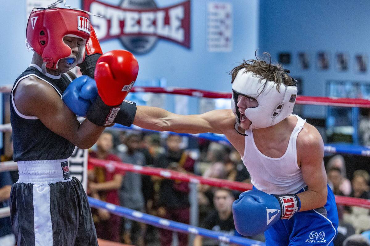 Geno Spatafora, right connects with a punch to the chin of Malik Stoot in their 119-pound match ...