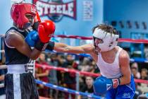 Geno Spatafora, right connects with a punch to the chin of Malik Stoot in their 119-pound match ...