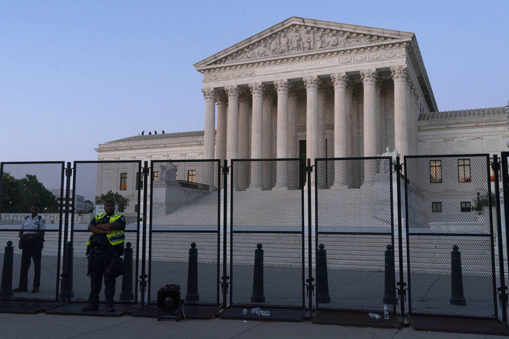 The Supreme Court is guarded at dusk, following the court's decision to overturn Roe v. Wade in ...