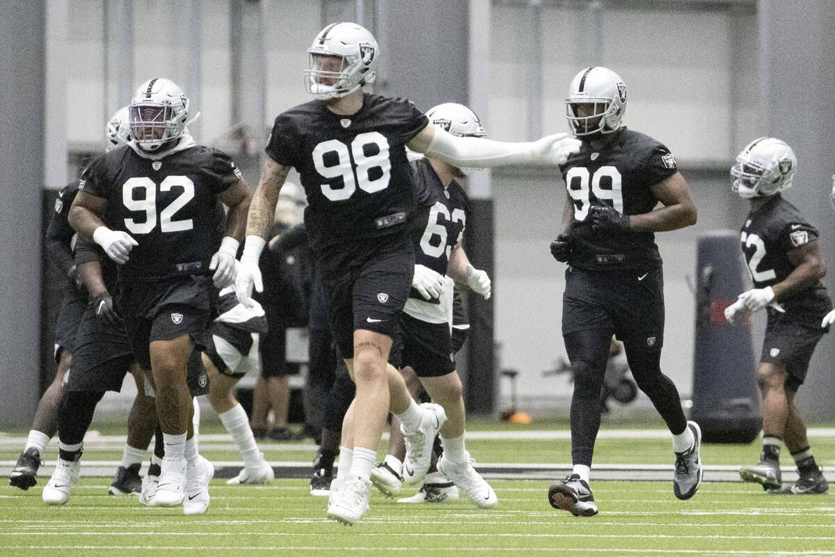 Raiders defensive tackle Kyle Peko (92), Raiders defensive end Maxx Crosby (98), and Raiders de ...