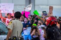 Protesters yell at Metro officers after they arrested two individuals during a march downtown i ...