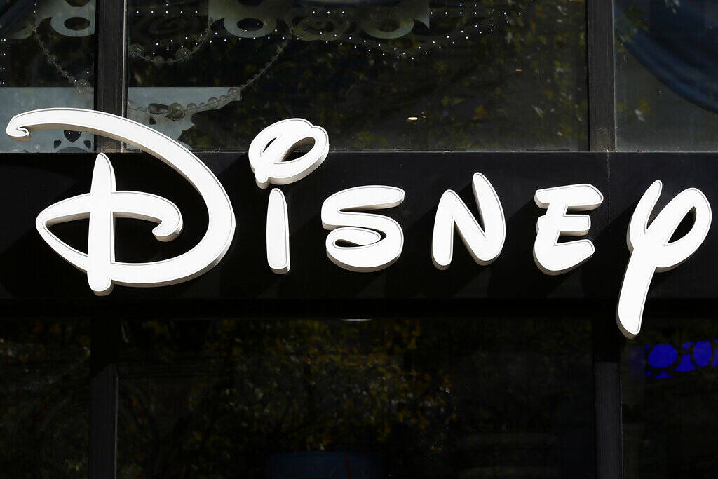 FILE - This Sept. 20, 2017, file photo shows a sign at the Disney store on the Champs Elysees A ...