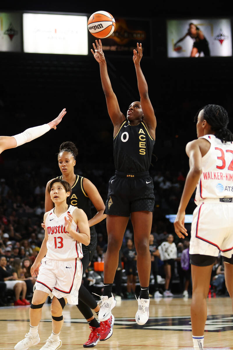 Las Vegas Aces guard Jackie Young (0) takes a shot under pressure from Washington Mystics forwa ...