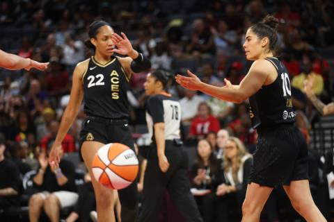 Las Vegas Aces guard Kelsey Plum (10) reaches for hand of forward A'ja Wilson (22) after scorin ...