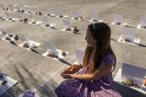 Cherish Berkey, 10, looks out at a memorial to the unborn display while holding a replica of an ...