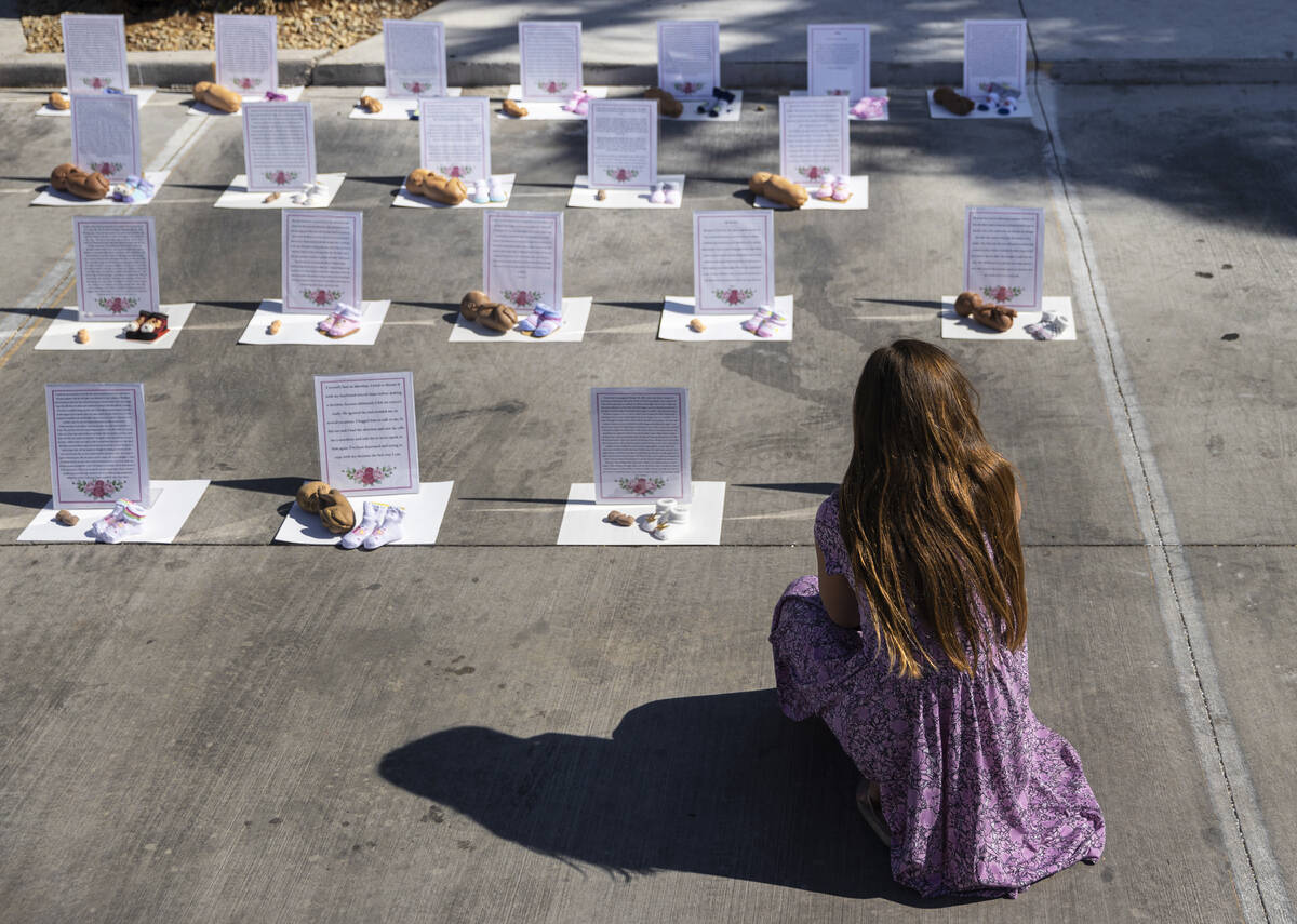 Cherish Berkey, bottom/right, 10, looks at a memorial to the unborn during the anti-abortion ra ...