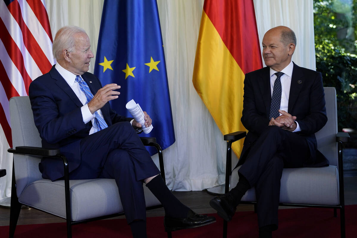 President Joe Biden and German Chancellor Olaf Scholz speak during a bilateral meeting at the G ...