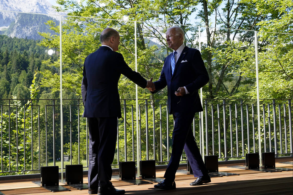 President Joe Biden and German Chancellor Olaf Scholz meet and shake hands during a bilateral m ...