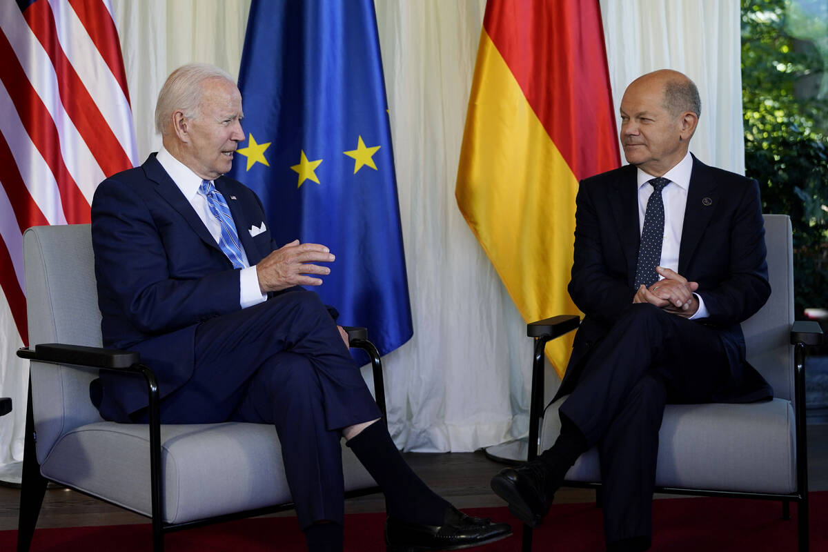 President Joe Biden and German Chancellor Olaf Scholz speak during a bilateral meeting at the G ...
