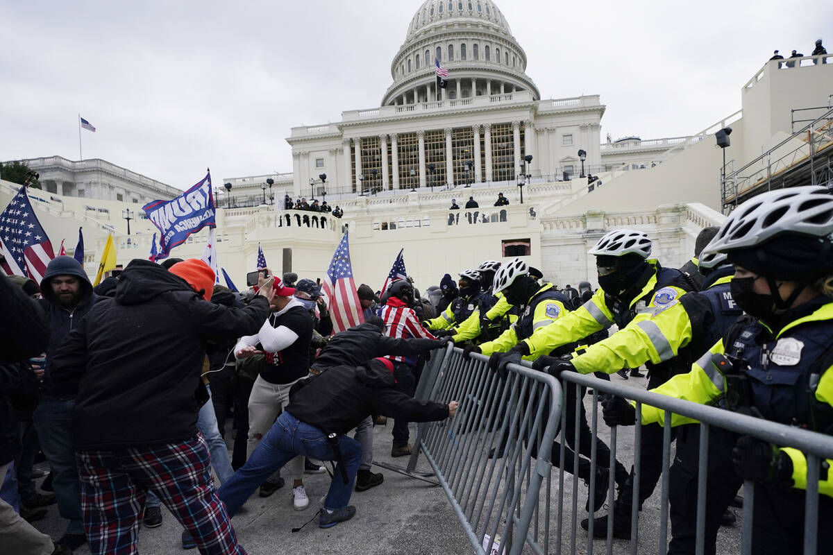 FILE - In this Wednesday, Jan. 6, 2021 file photo, Trump supporters try to break through a poli ...
