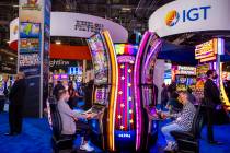 Attendees play the Carnival of Wonders machines in the IGT display space during day 2 of the Gl ...