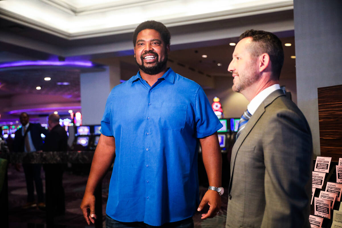 Football Hall of Famer Jonathan Ogden, left, speaks with Dan Walsh, senior vice president and g ...