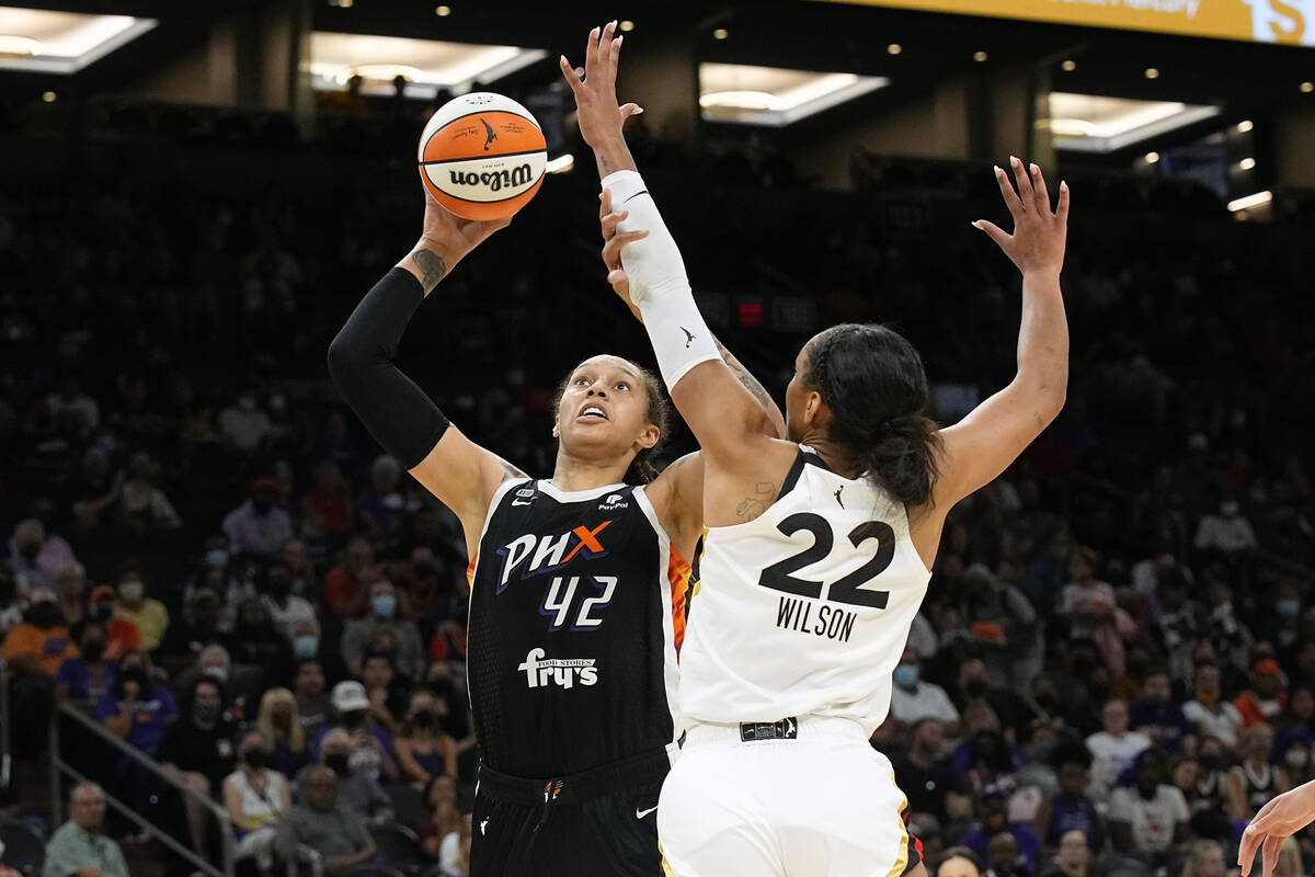 Phoenix Mercury center Brittney Griner drives on Las Vegas Aces forward A'ja Wilson (22) during ...